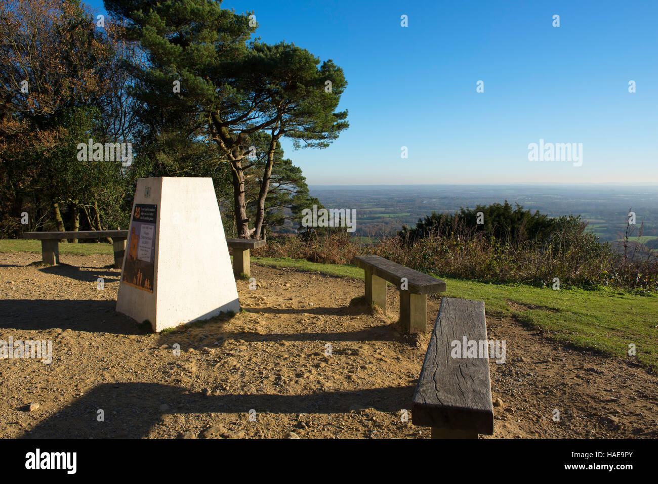 The trig point on Leith Hill adjacent to the tower looking out to the Surrey countryside in autumn Stock Photo
