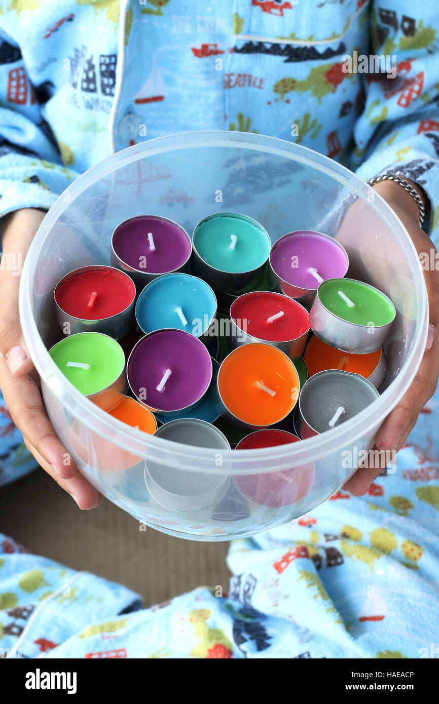 Child holding Colorful scented candles Stock Photo