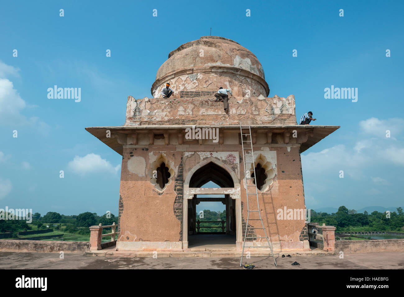 Repair work going on the Jahaz Mahal or 'Ship Palace' in the Royal Enclave is the main tourist attraction in Mandu, Madhya Pradesh, India Stock Photo