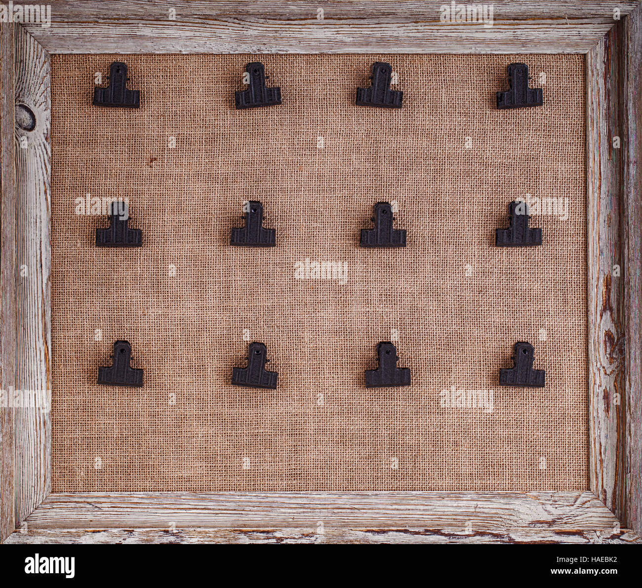 Notice board with hessian backing and twelve clips for holding notes