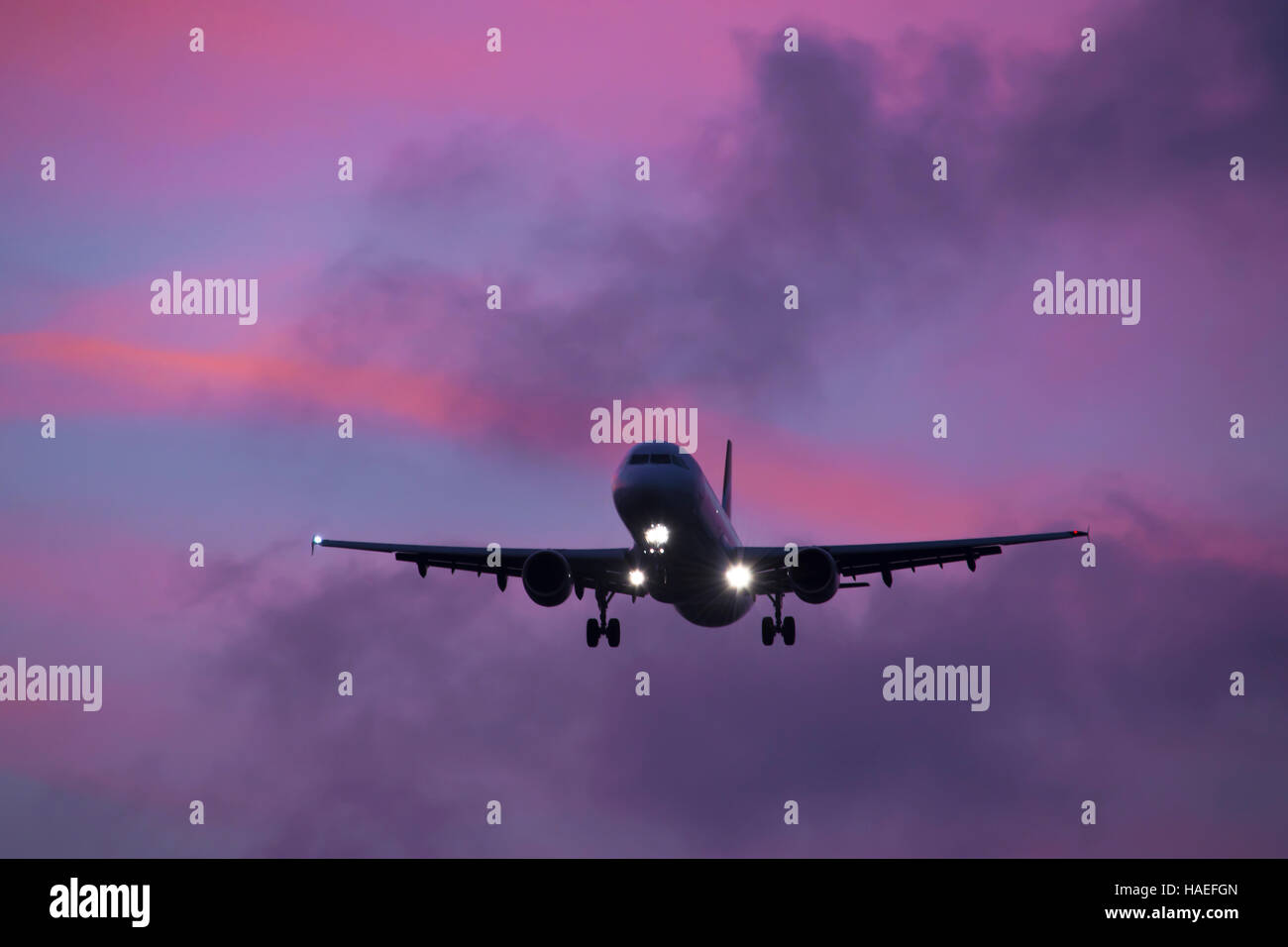 Plane landing during Sunset, at London Heathrow Airport Stock Photo