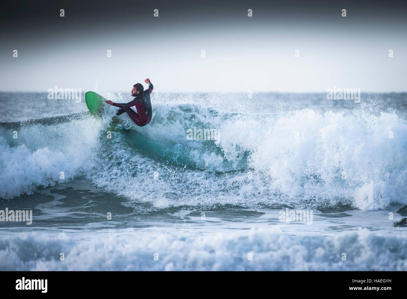 A surfer rides a wave at Fistral in Newquay; Cornwall. UK Stock Photo ...