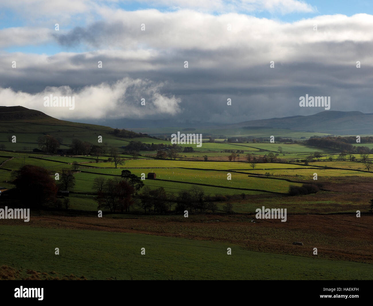 clouds and soft light over barn & fields near Orton in Cumbria UK looking towards the Yorkshire fells beyond Kirkby Stephen Stock Photo