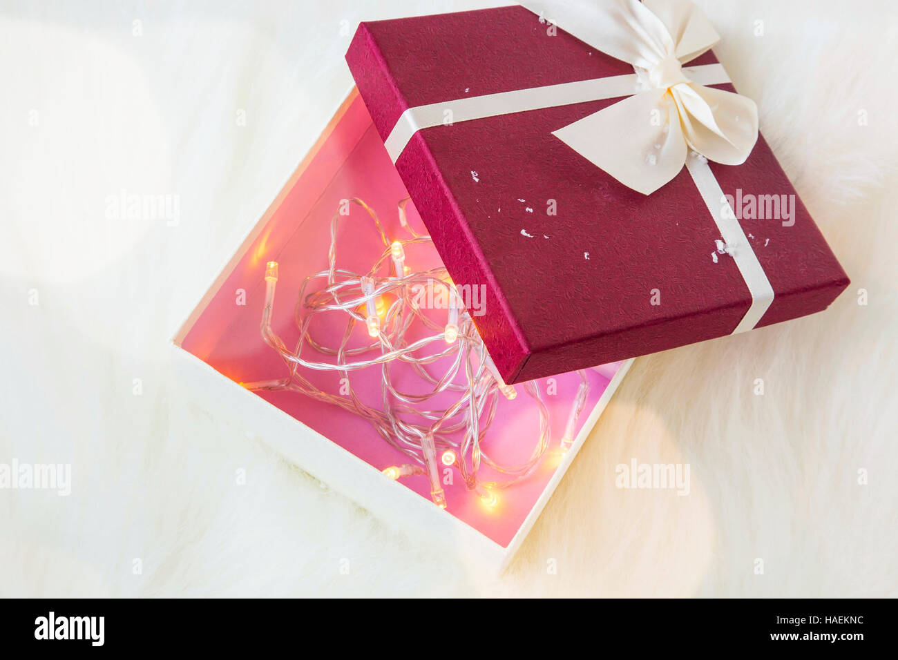 Festive Christmas Gift Box Decorated With Tree Lights Inside Stock