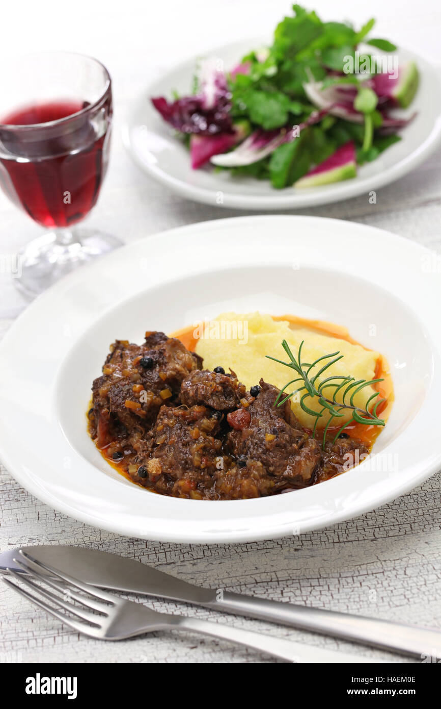 peposo with polenta, tuscan peppered beef stew, traditional italian cuisine Stock Photo