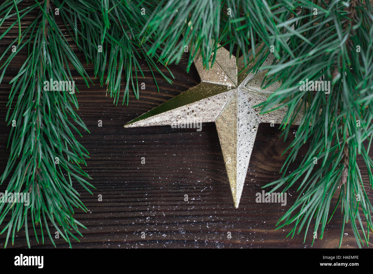 Christmas composition of golden star ornament and xmas tree branches on ...
