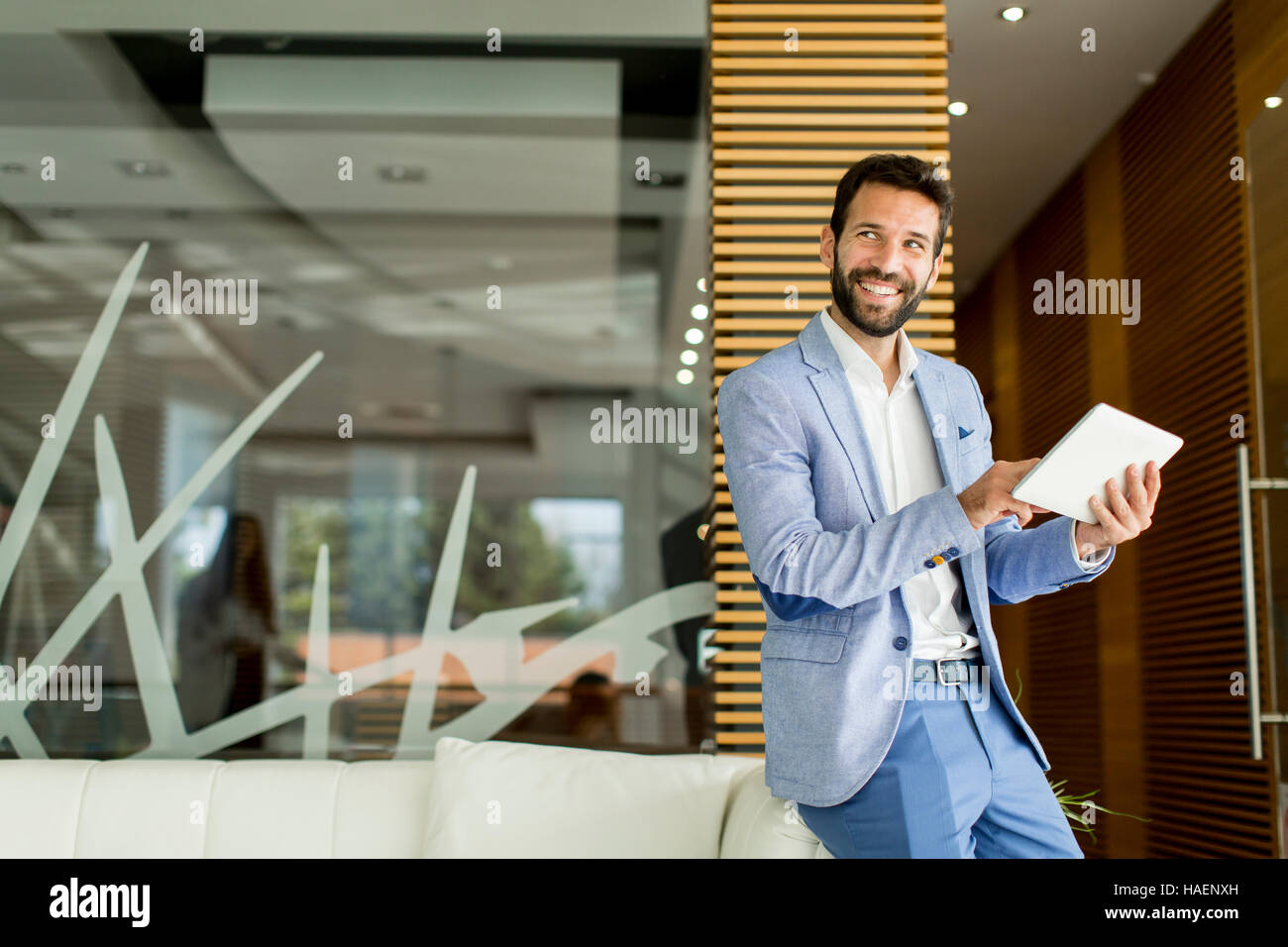 Businessman using his digital tablet at the office Stock Photo - Alamy