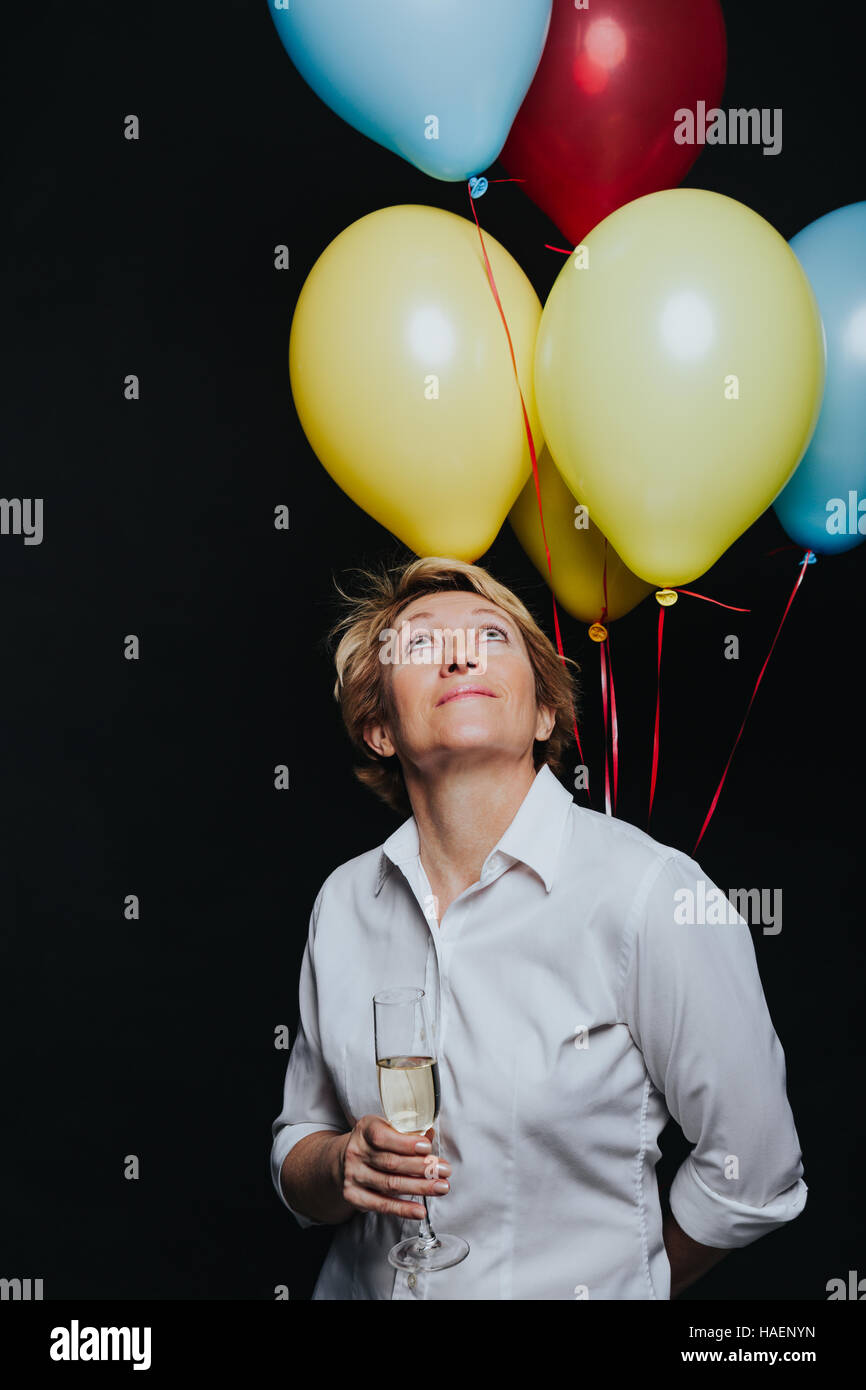 Happy woman with balloons and wineglass Stock Photo