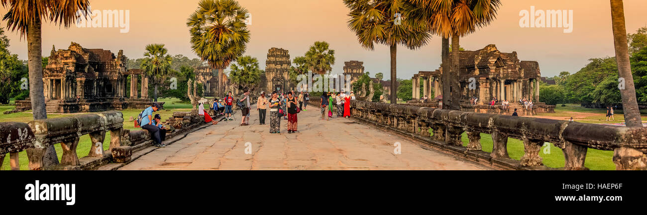 Tourists enter the Angkor Wat temple complex earling morning to witness sunrise in Siem Reap, Kingdom of Cambodia. Stock Photo