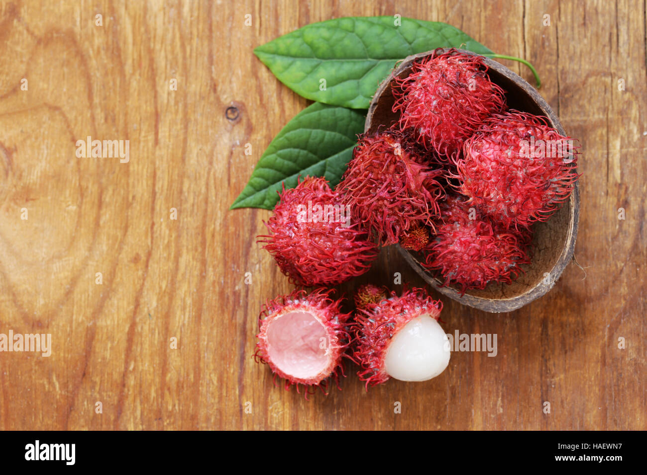 Natural organic lychee fruit (rambutan) on a wooden table Stock Photo