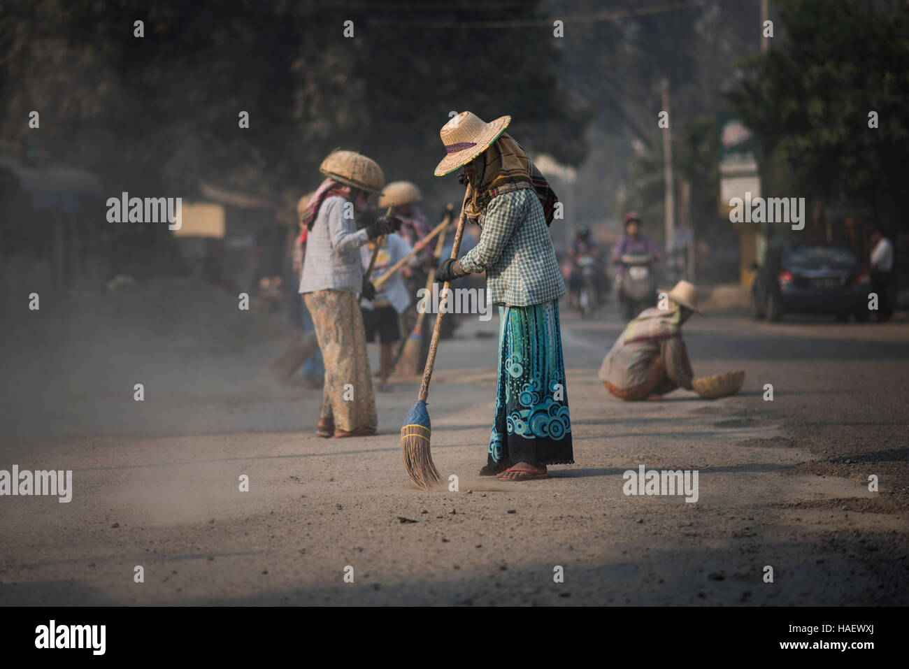 A group of women cleaning the road before laying tar, Bagan, Myanmar. Stock Photo