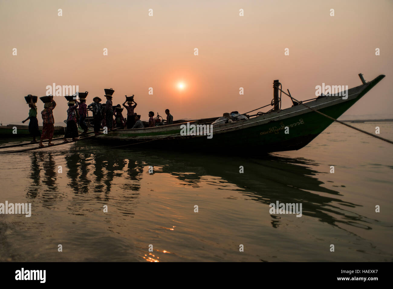 Women unloading gravel along the Ayeyarwaddy River near Bagan, Myanmar. Stock Photo