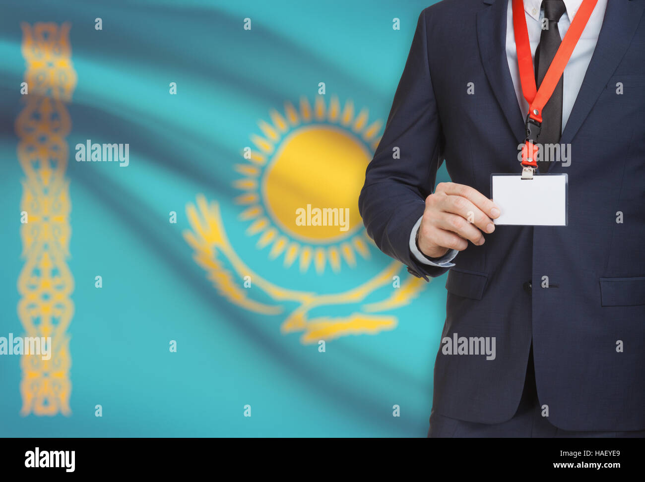 Businessman holding name card badge on a lanyard with a flag on background - Kazakhstan Stock Photo