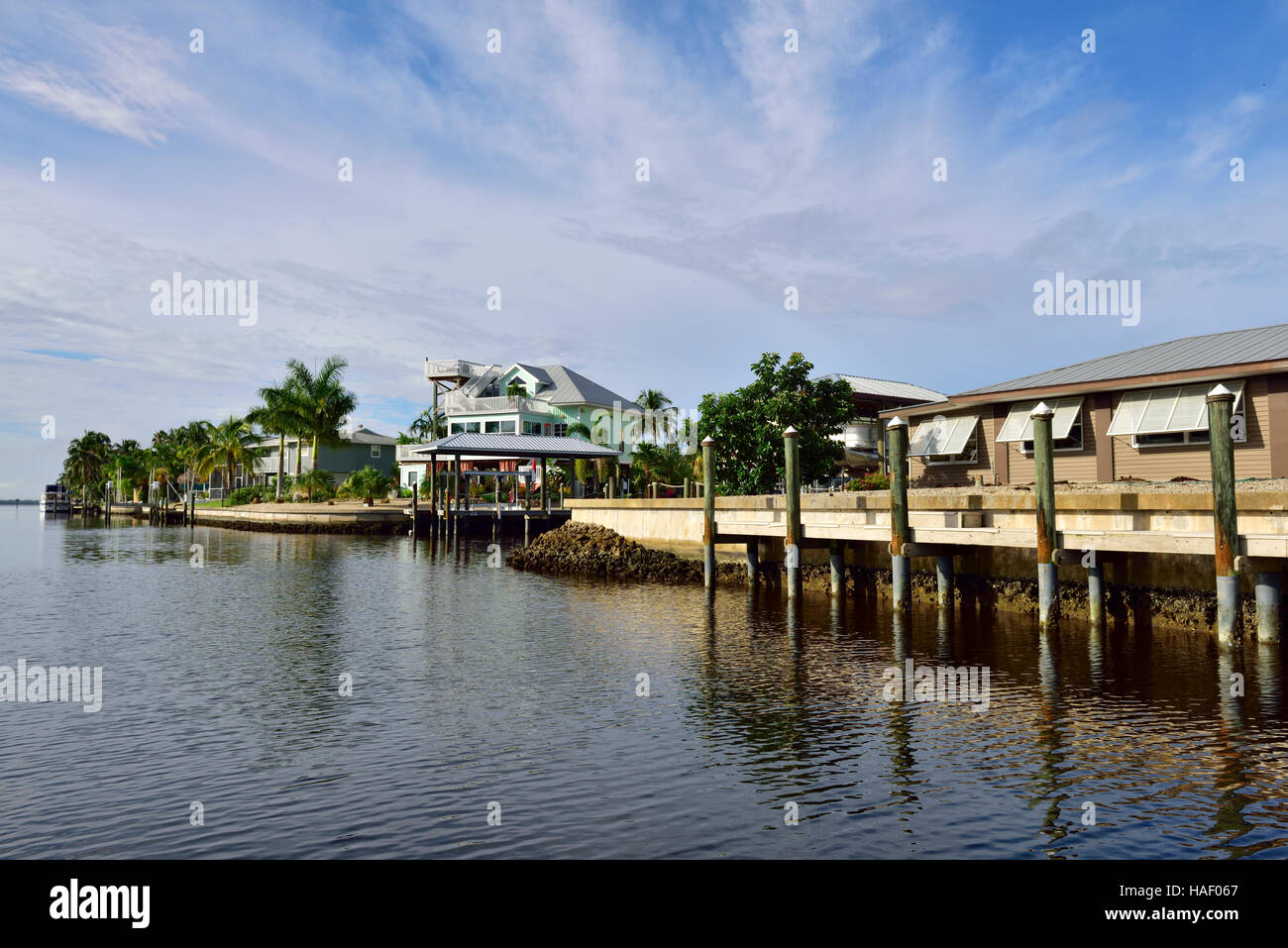 Houses on canal in residential neighborhood with docks and boats at