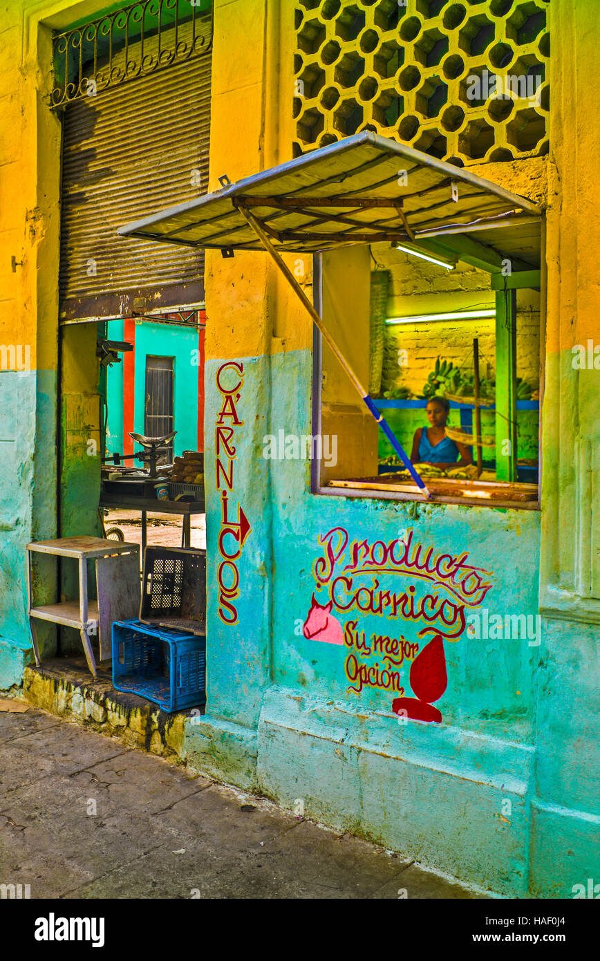 Productos Carnicos state owned butcher colourful yellow and green painted shop front, Havana Cuba Stock Photo