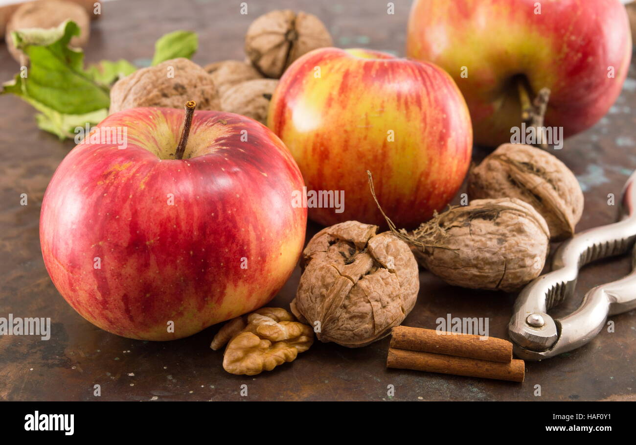 Apples, walnuts and nuts cracker on a table Stock Photo