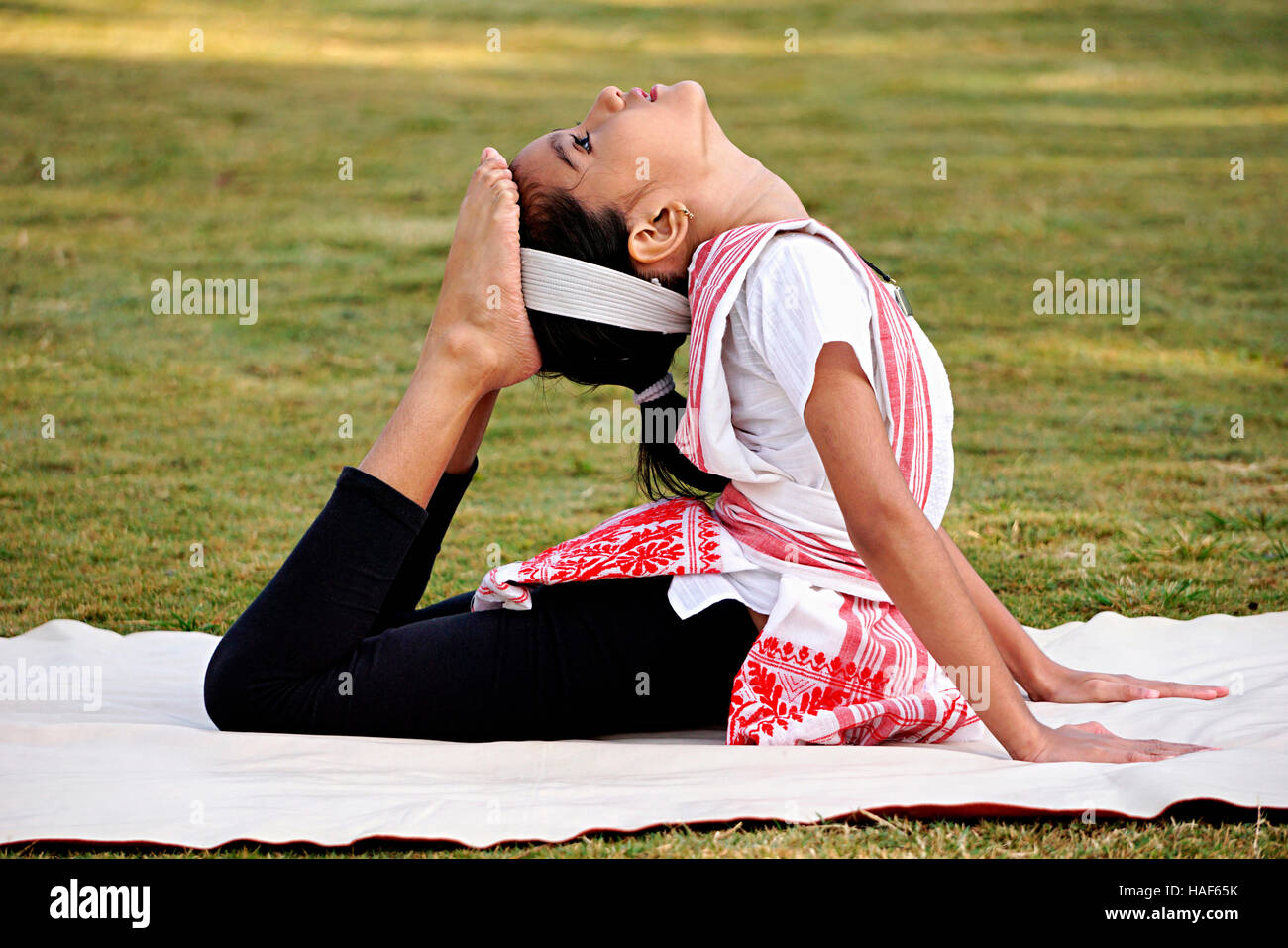 Girl doing a sequence of the Mati akhora called Teltupi for the flexibility  of Back bone, Pune, Maharashtra Stock Photo - Alamy