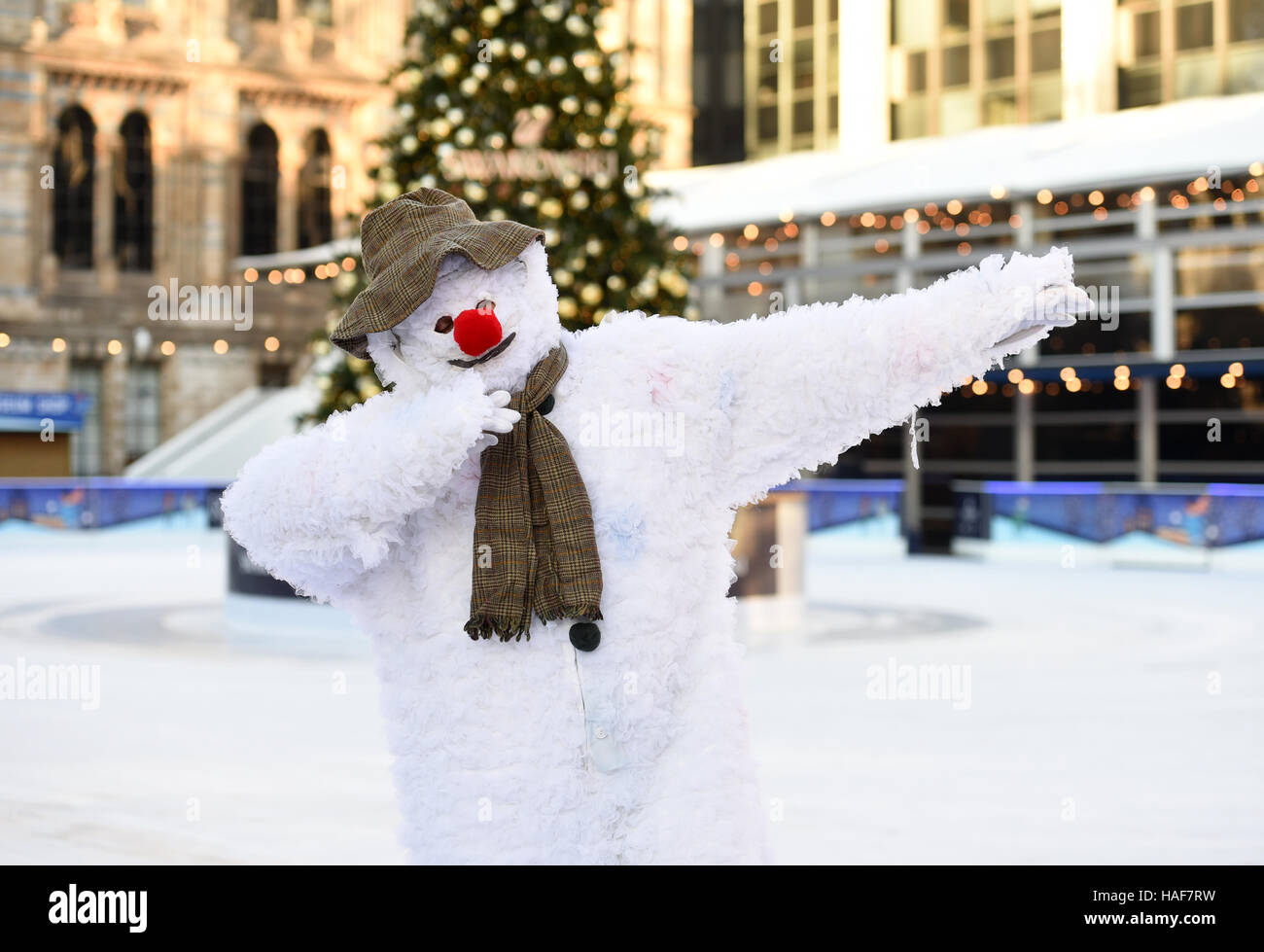 An actor plays The Snowman during a photo call at the Natural History Museum Ice Rink for the theatre production of The Snowman, running at the Peacock Theatre in London. Stock Photo