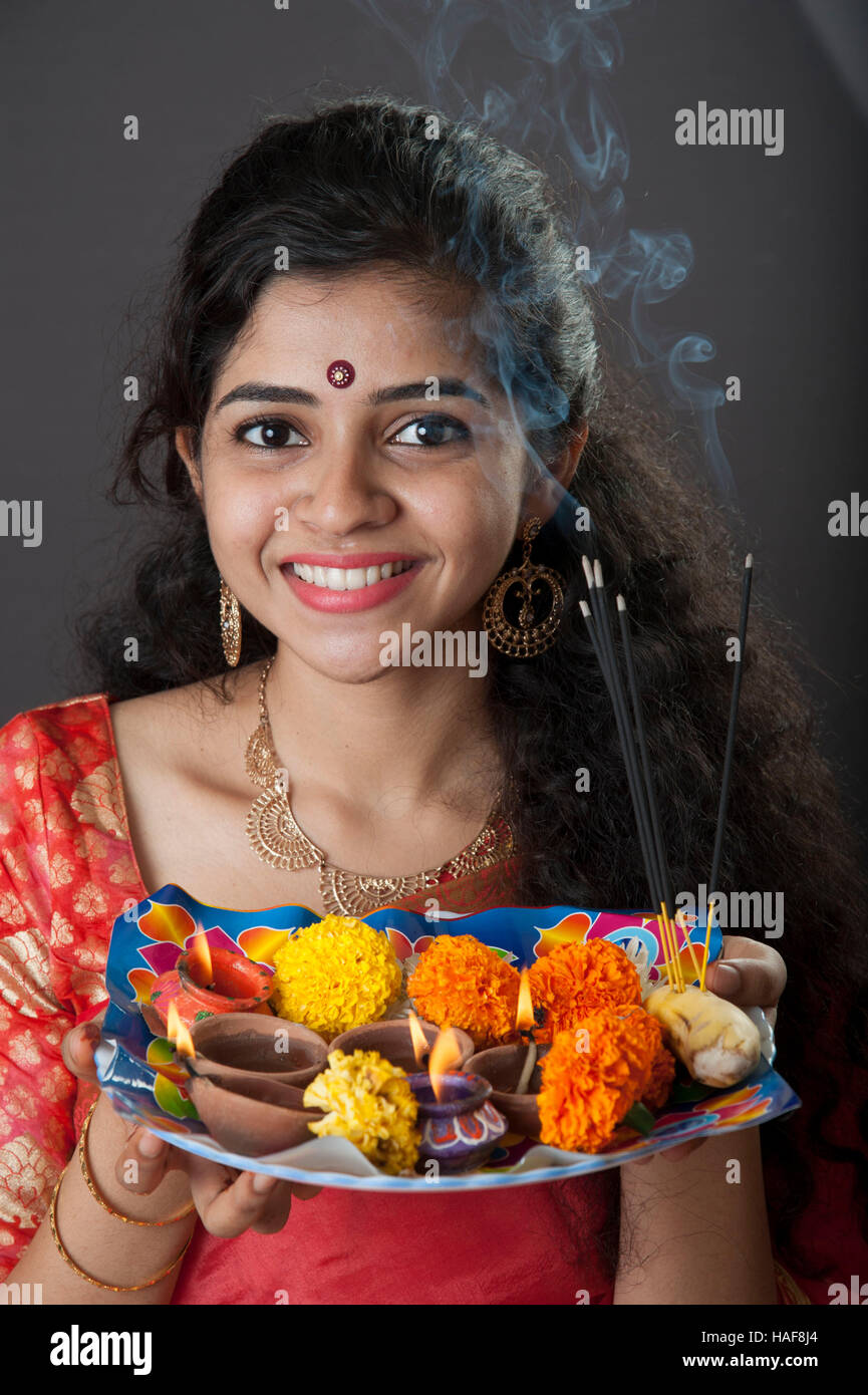a girl smiling and holding a traditional Diwali thali Mumbai maharashtra India Stock Photo