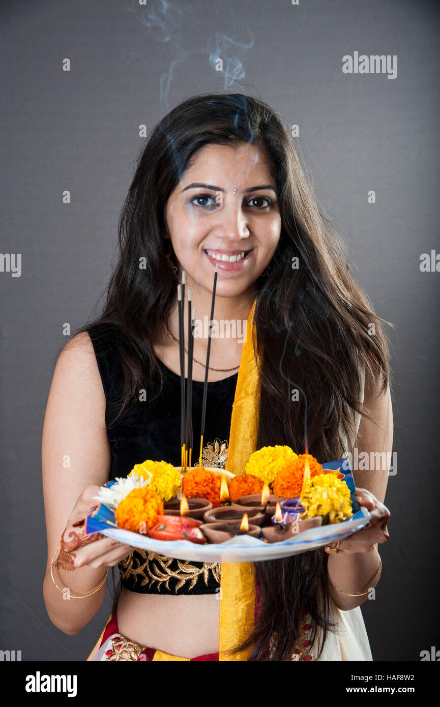 a girl smiling and holding a traditional Diwali thali Mumbai maharashtra India Stock Photo