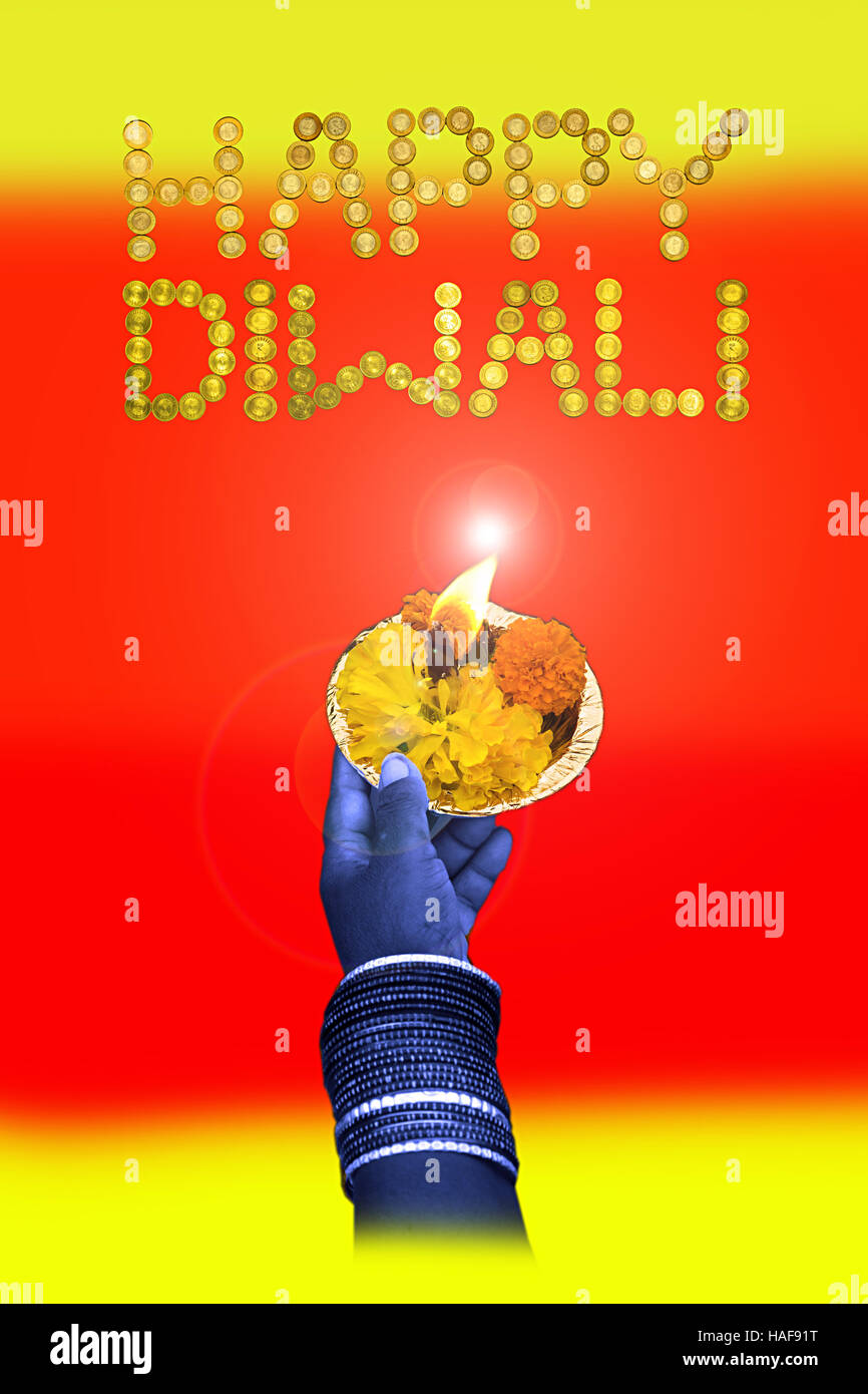 diwali greeting card with ten Rupee coin and  floating flowers and oil lamp mumbai  maharashtra India Stock Photo