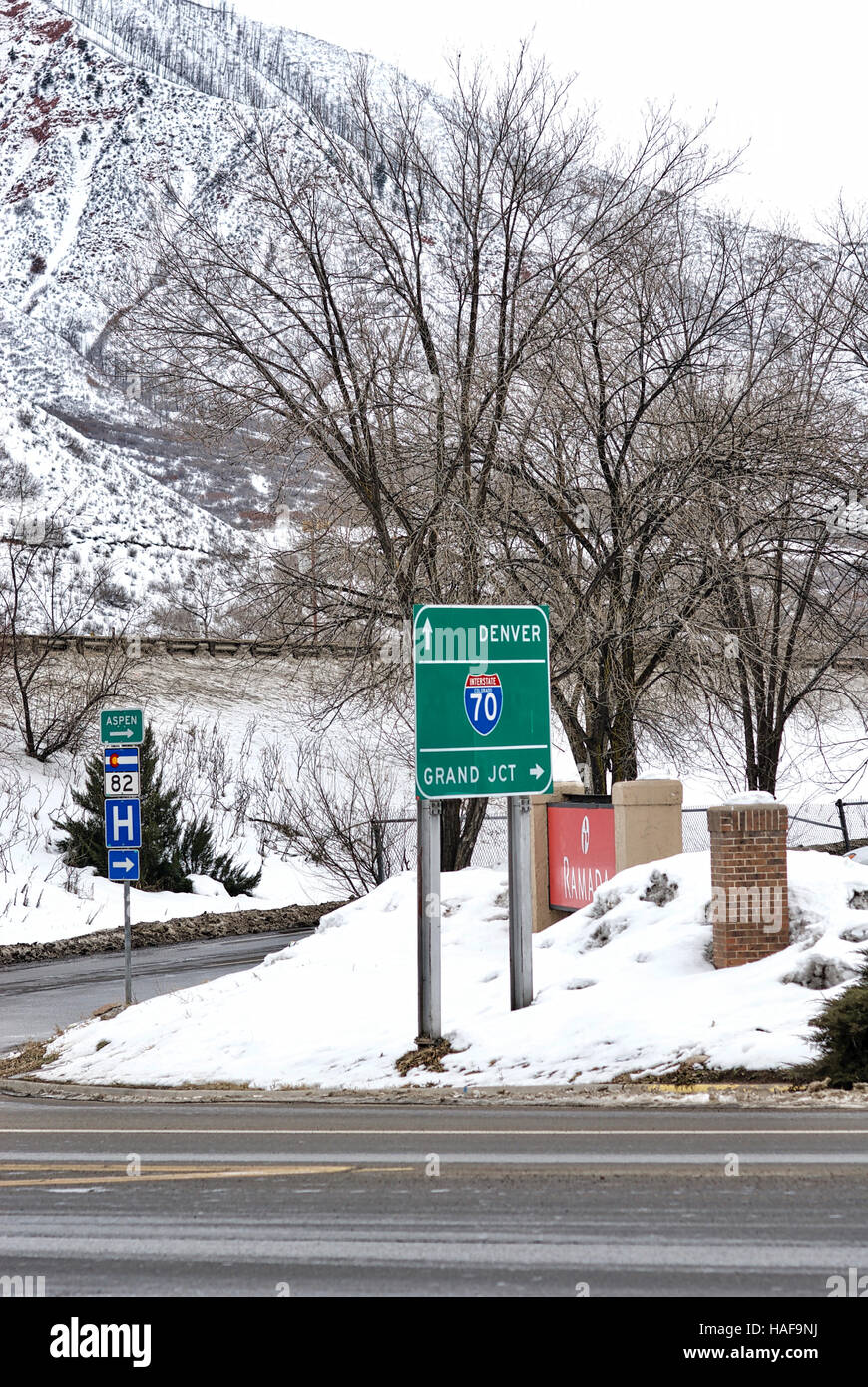 Directional road signs for Interstate 70, Colorado Highway 82, and a hospital in Glenwood Springs, Colorado, on a winter day. Stock Photo