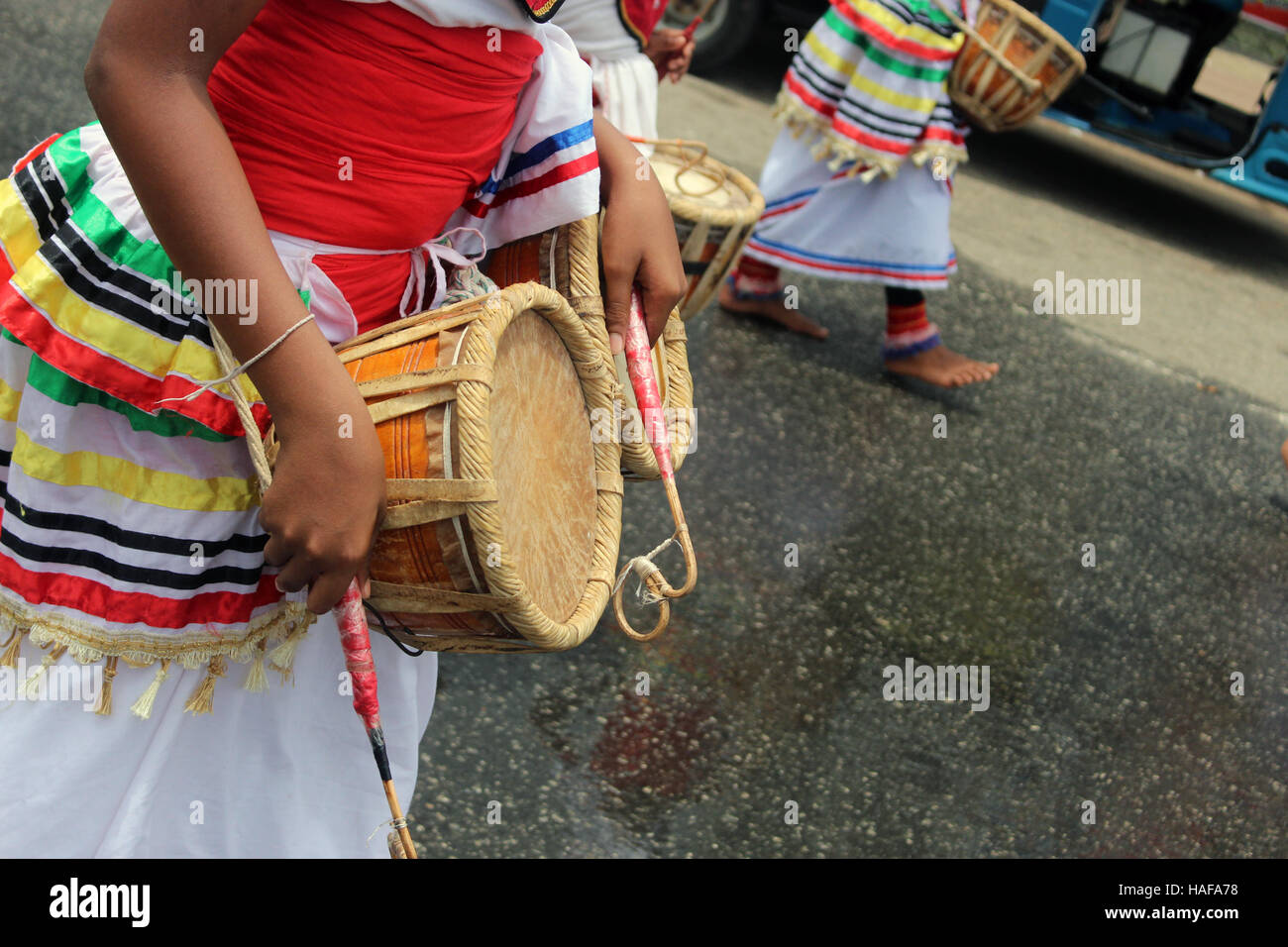 sri lankan traditional drummer playing a traditional drum called