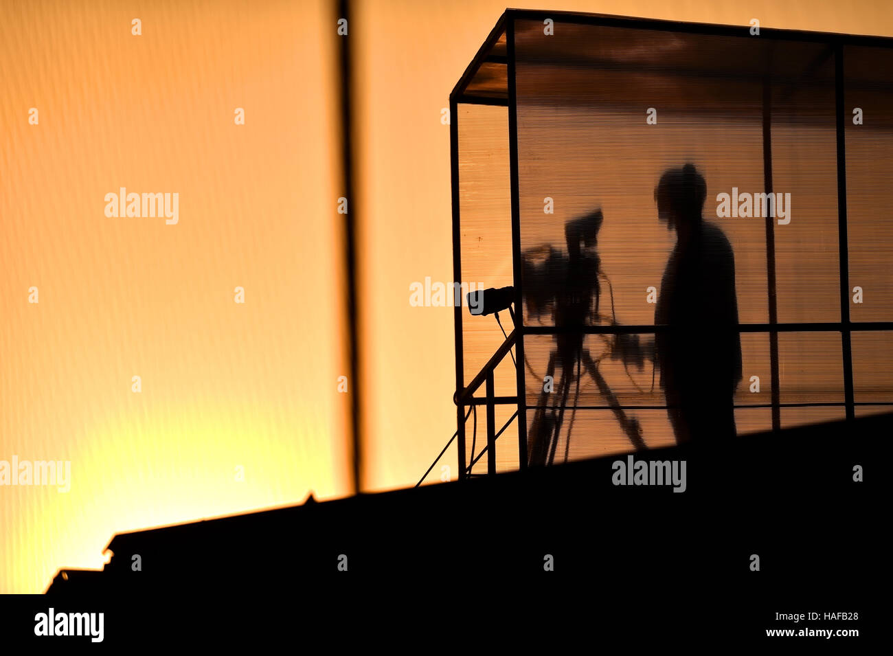 Cameraman's silhouette broadcasting live from a stadium Stock Photo