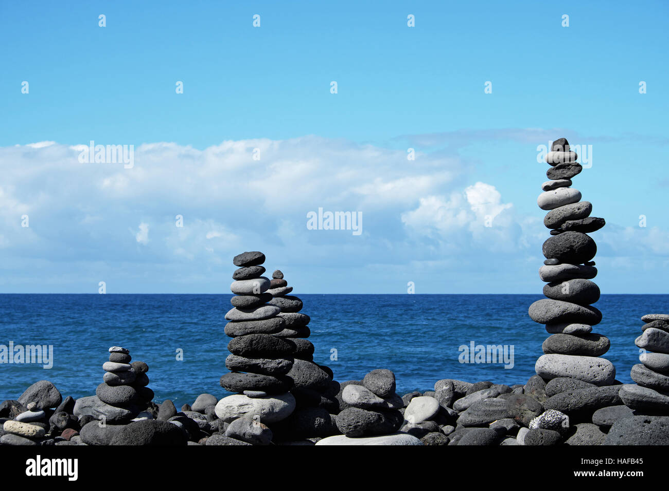 stacked stone pyramids at pebble stone beach Stock Photo