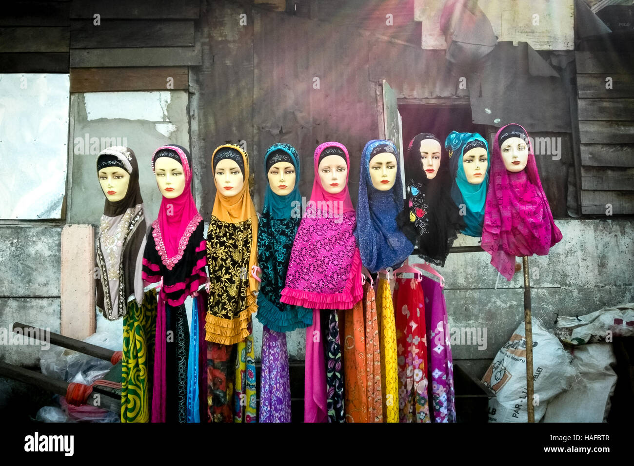 Row of mannequins displaying colourful dresses in street market of Jakarta, Indonesia. Stock Photo