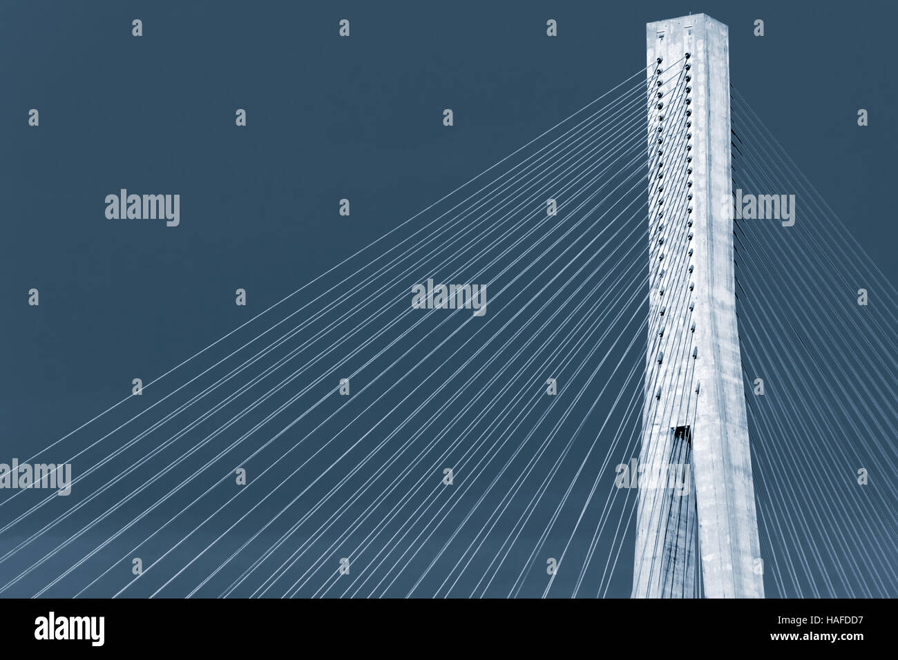 Blue toned photo of Skarnsund Bridge, modern automotive cablestayed
