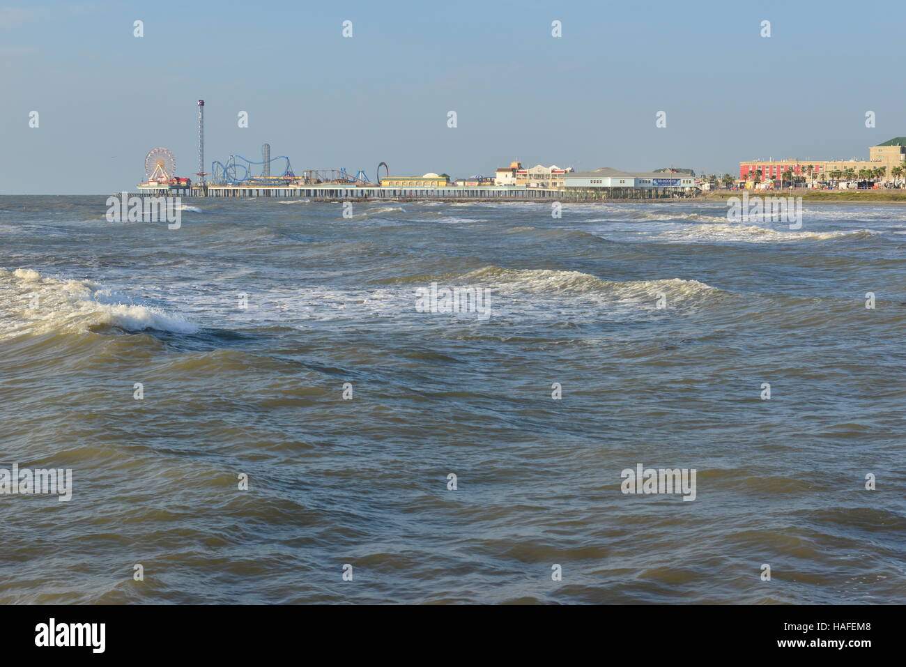 Galveston Seafront from a stone footpath leading out into the sea. Stock Photo