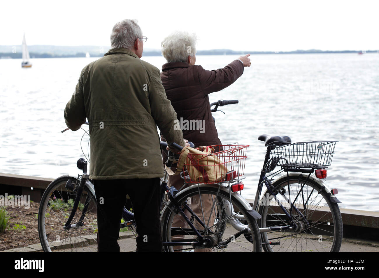 A retired pair going for a ride on bicycles at the Steinhuder See, in Steinhude (Hannover, Lower Saxony, Germany). Stock Photo