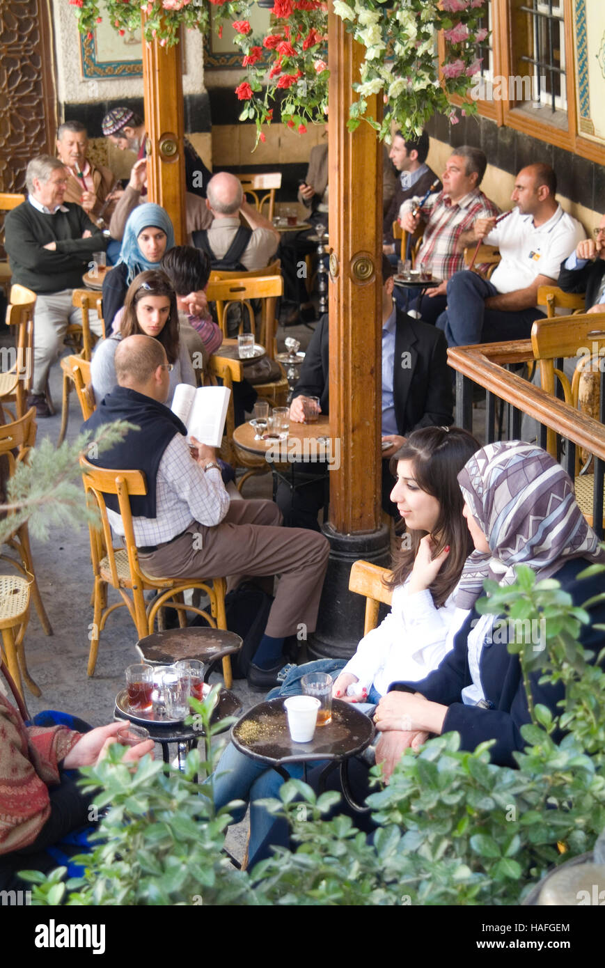 Relaxing over a shisha pipe at Al Nofaraa Cafe in the Old Town of Damascus, Syria. Stock Photo