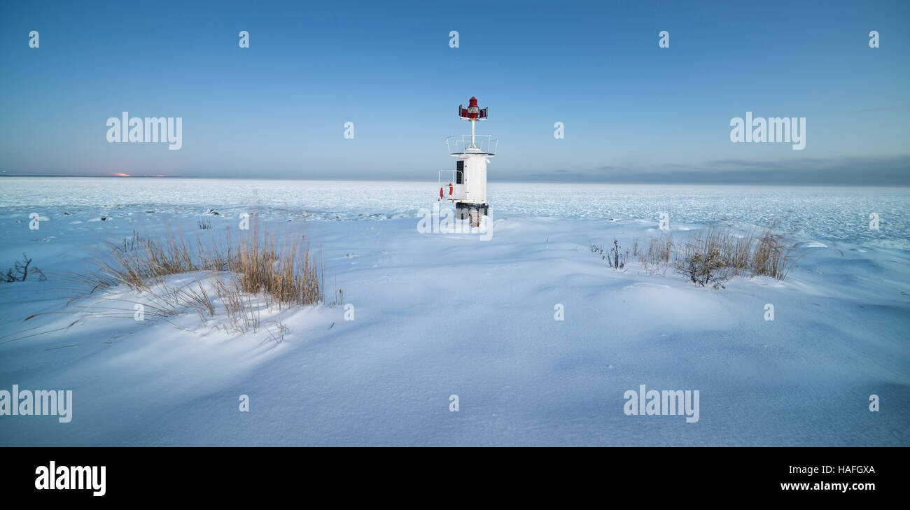 Small lighthouse in the snow at the coast of Roslagen, Uppland on a cold winter morning at dawn, Sweden, Scandinavia Stock Photo