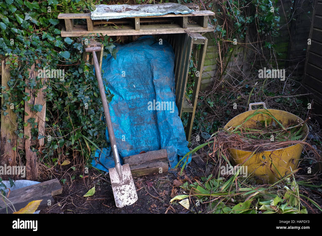 A compost heap covered with a plastic sheet to prevent the rain getting