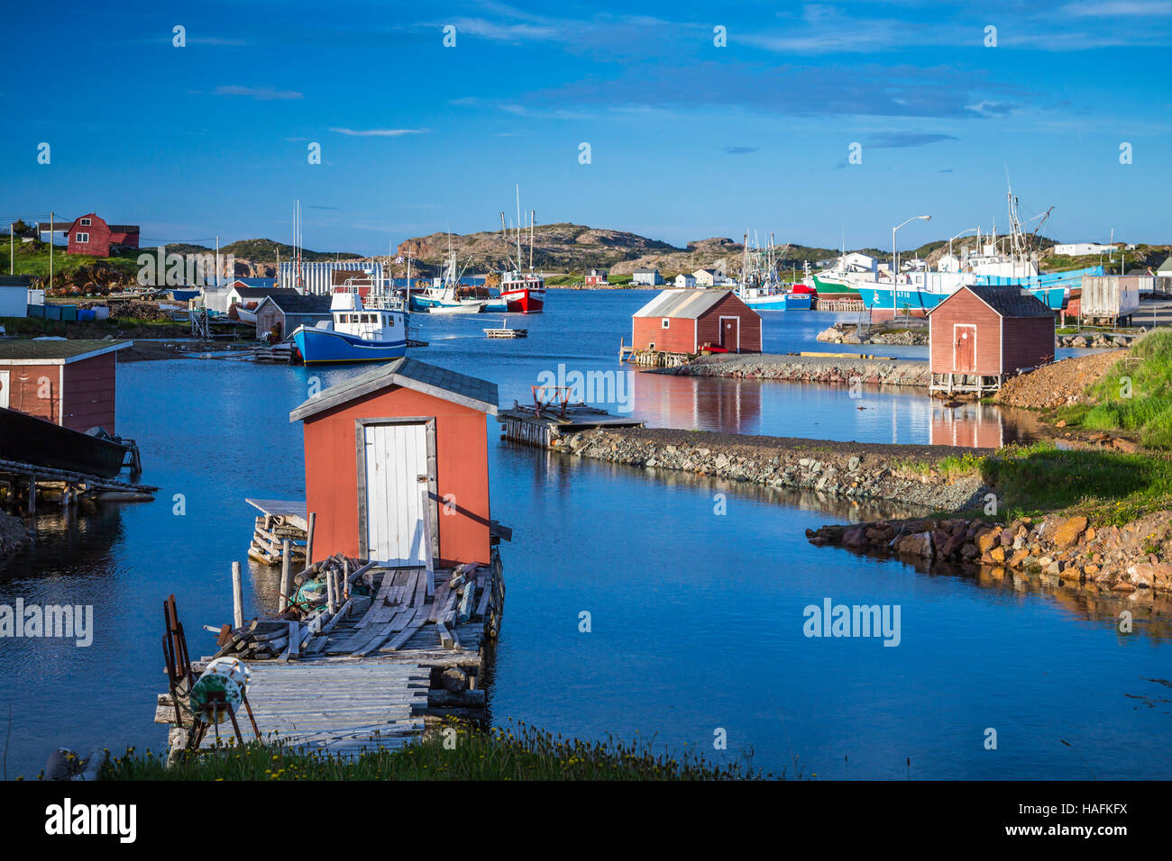Reflections of fishing stages and boats near Twillingate, Newfoundland and Labrador, Canada Stock Photo