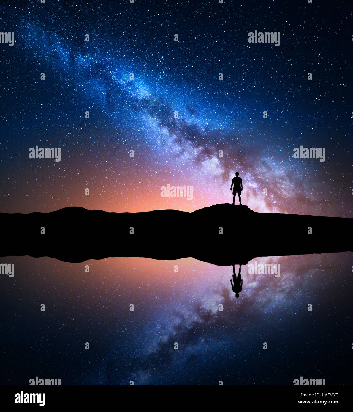 Milky Way. Night sky with stars and silhouette of a standing alone man ...