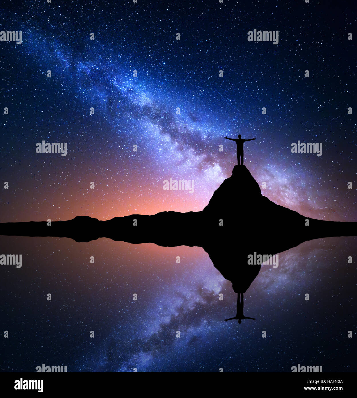 Milky Way. Night starry sky and silhouette of a standing happy man with ...