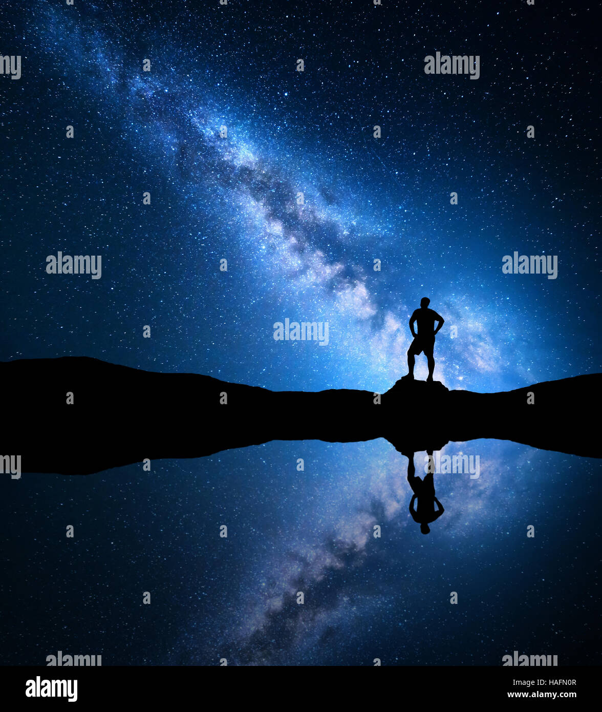 Milky Way. Night sky with stars and silhouette of a standing alone man ...