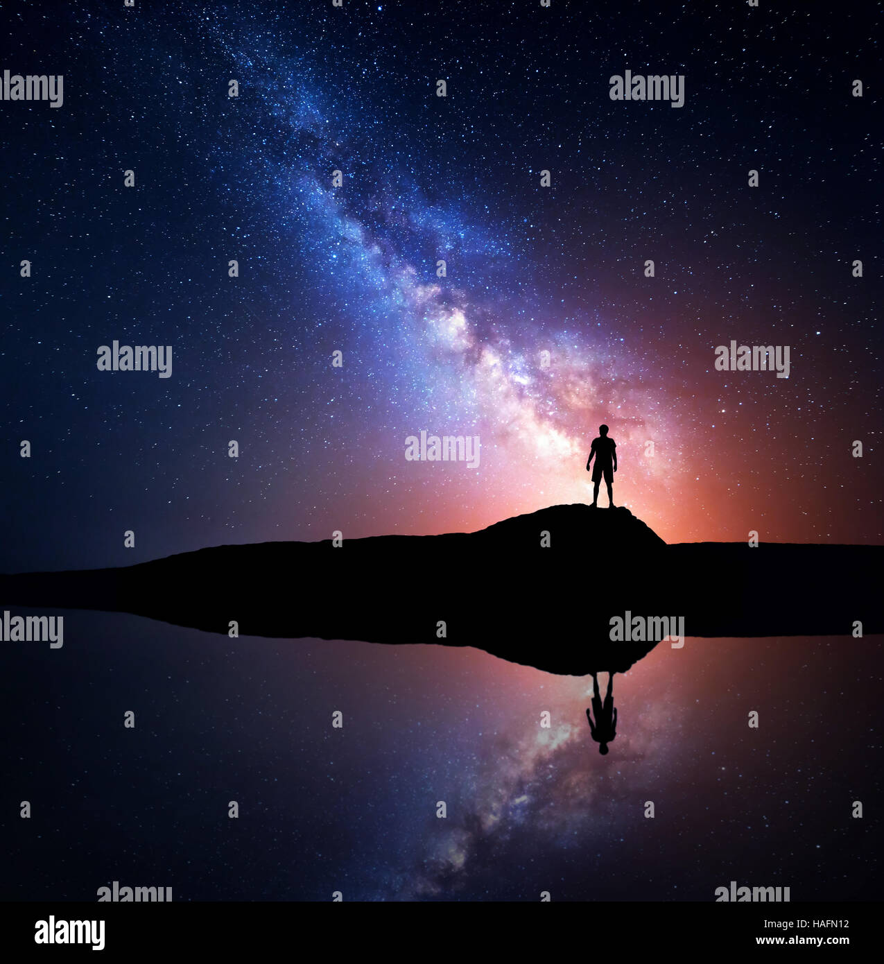 Milky Way. Night sky with stars and silhouette of a standing alone man ...
