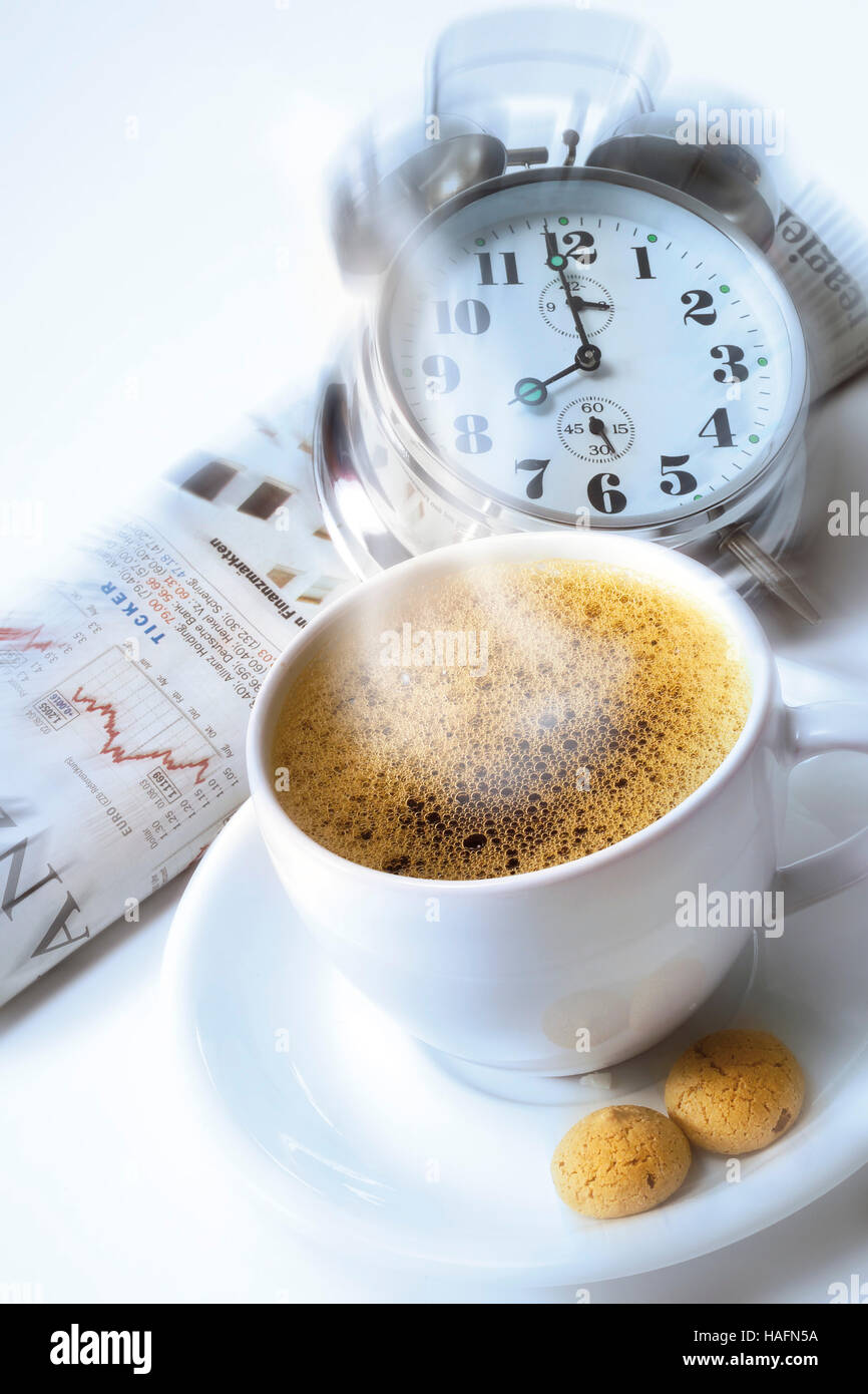 Coffee cup with alarm clock and newspaper Stock Photo Alamy