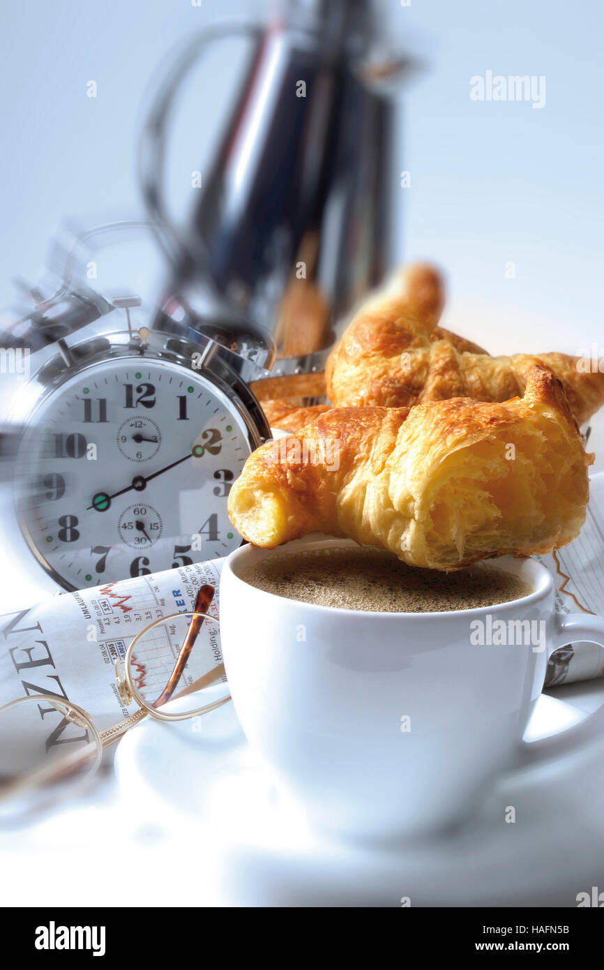 Coffee cup with croissant and alarm clock Stock Photo - Alamy