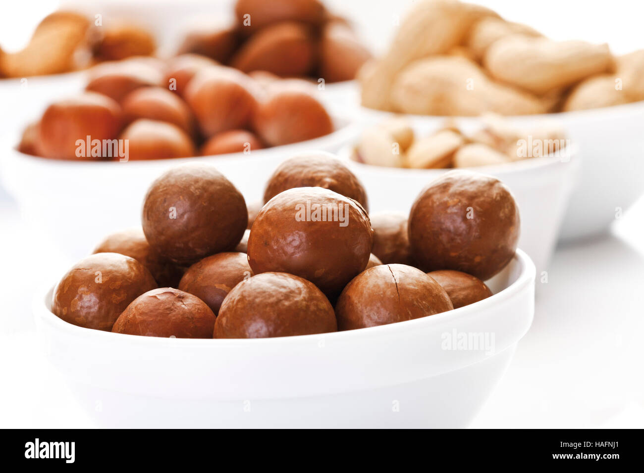 Assorted nuts in ceramic bowls, macadamia nuts, walnuts, peanuts