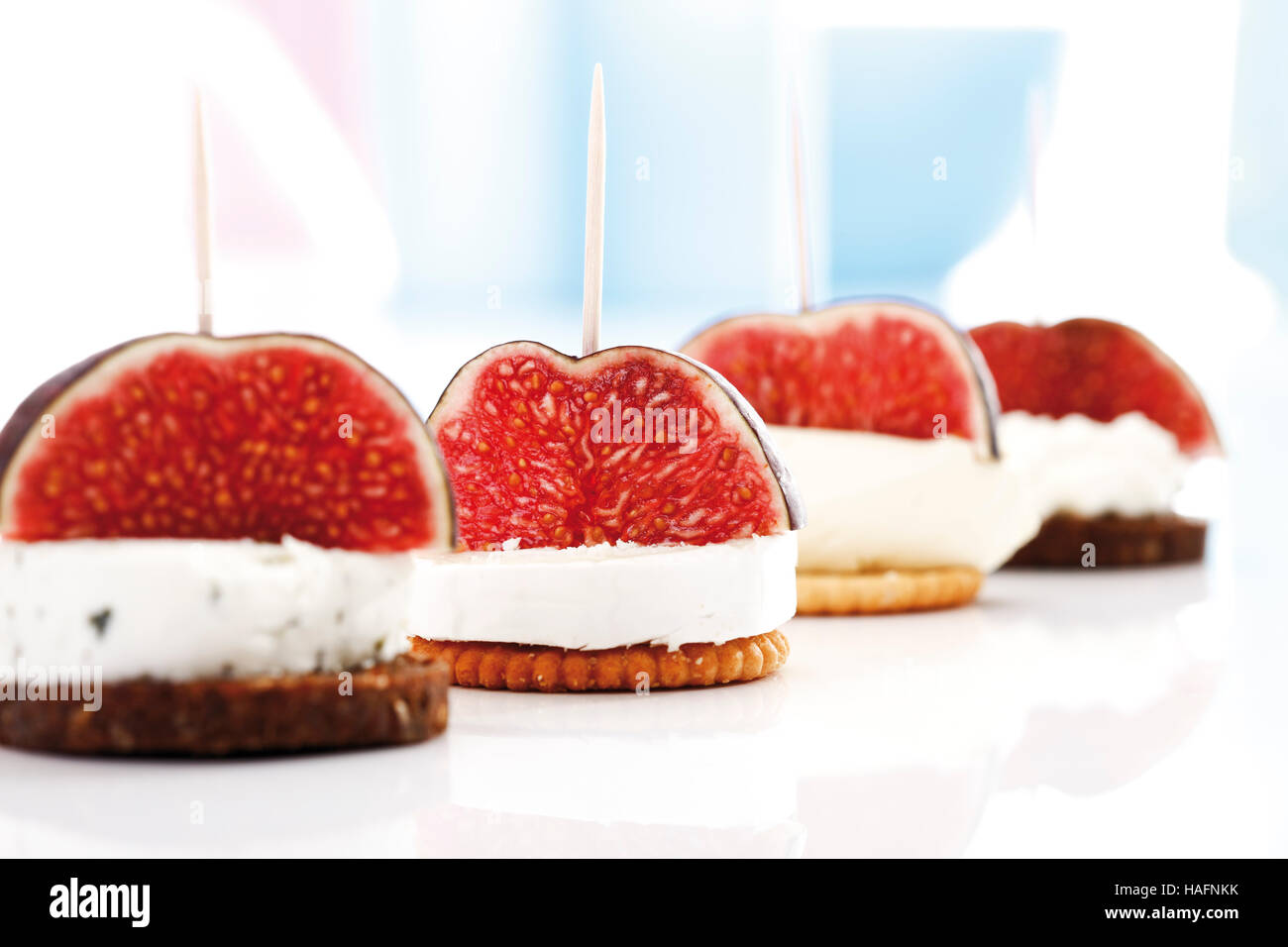 Finger food, crackers and pumpernickel topped with figs and assorted