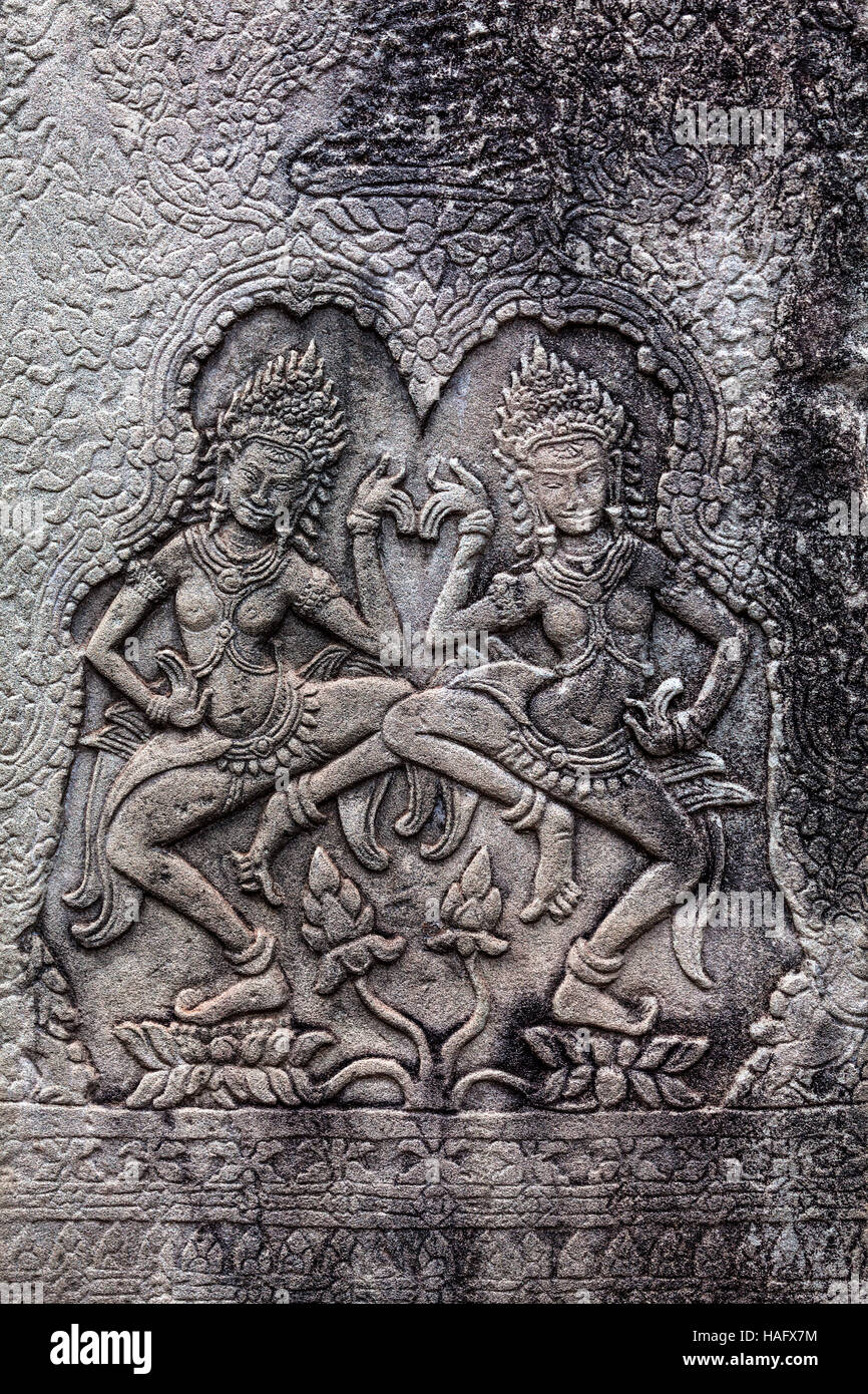 Bas-relief carving of traditional Apsaras dancing at the Prasat Bayon temple, Angkor Thom, Siem Reap, Kingdom of Cambodia. Stock Photo