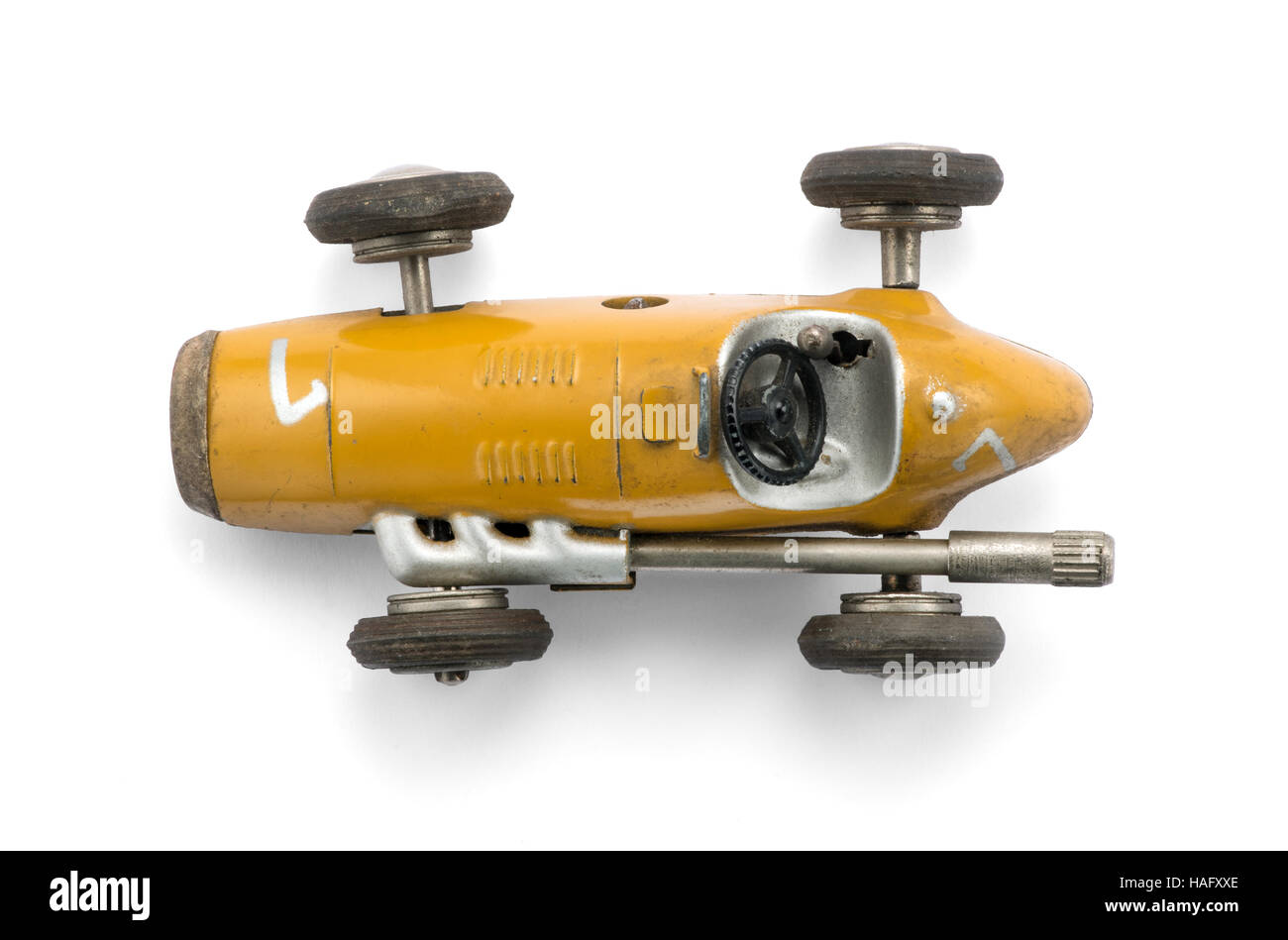Vintage yellow toy racing car , top view on white background with natural shadow Stock Photo