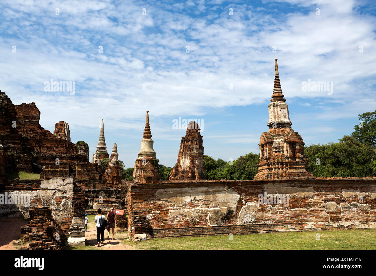 People visiting the Wat Mahathat temple complex in Ayutthaya, central Thailand Stock Photo