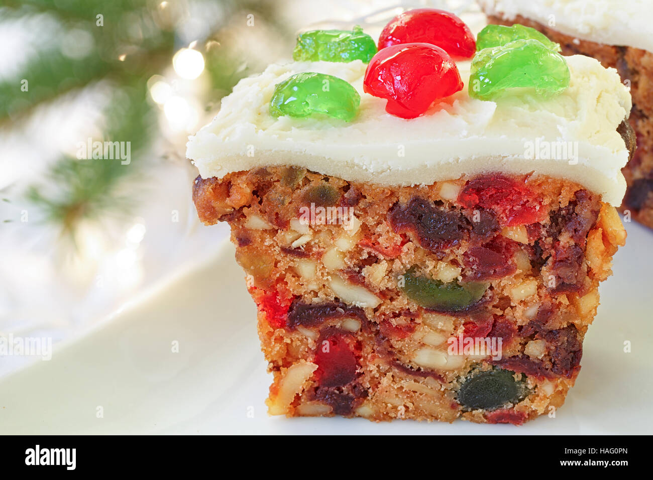 Homemade Christmas fruitcake with candied cherry decorations. Stock Photo