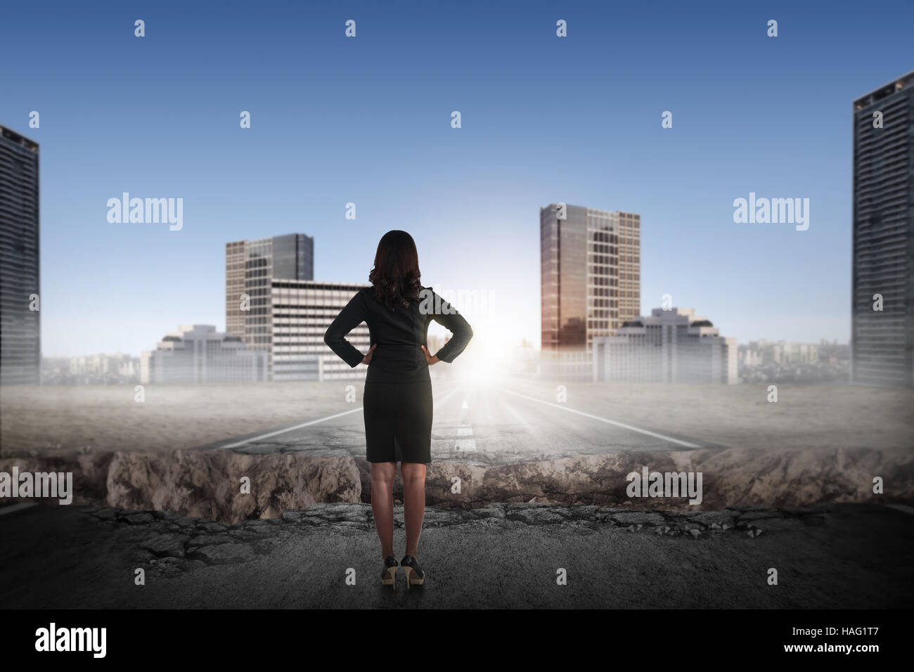Back view of asian business woman looking the city from broken road ...